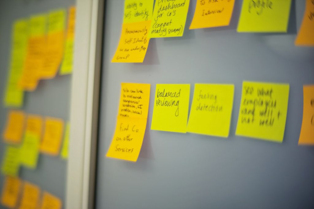 Wall of sticky notes from a design sprint used to plan app screens and features